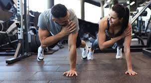 Sculpting Sleek Arms: The Essential Role of Cardio in Toning Without Bulking Up 1 Image of man and woman doing Cardio Market Harborough to tone their arms.